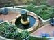 Beautiful courtyard with a stone fountain, seating area, and manicured landscaping at 855 Peachtree Ne St # 1406, Atlanta, GA 30308
