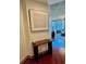 Entryway with wood flooring, console table, and modern art at 855 Peachtree Ne St # 1406, Atlanta, GA 30308