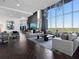 Elegant living room with floor to ceiling windows, stylish furniture, and hardwood floors at 855 Peachtree Ne St # 1406, Atlanta, GA 30308