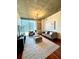 Living room with hardwood floors, neutral decor, and expansive windows overlooking the cityscape at 855 Peachtree Ne St # 1406, Atlanta, GA 30308