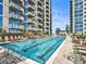 Outdoor swimming pool with lounge chairs and views of the surrounding high-rise buildings at 855 Peachtree Ne St # 1406, Atlanta, GA 30308