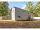 Exterior shot of home featuring a large fenced yard and plenty of trees at 2100 Scarbrough Rd, Stone Mountain, GA 30088