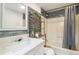 Bright bathroom featuring a shower/tub combo, vanity, and decorative accent wall at 2100 Scarbrough Rd, Stone Mountain, GA 30088