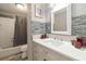 Well-lit bathroom with a combination shower and tub at 2100 Scarbrough Rd, Stone Mountain, GA 30088