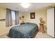 Cozy bedroom with neutral tones featuring a queen sized bed and chair at 2100 Scarbrough Rd, Stone Mountain, GA 30088