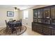 Comfortable dining area with a dark table set and glass cabinet with hardwood floors at 2100 Scarbrough Rd, Stone Mountain, GA 30088