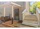Exterior entrance featuring white painted wood stairs and a security door at 2100 Scarbrough Rd, Stone Mountain, GA 30088