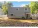 Rear exterior view of home with trees, fenced yard, and access to the back entrance at 2100 Scarbrough Rd, Stone Mountain, GA 30088