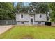 Inviting home featuring a lush green lawn and a secure, gated driveway at 2100 Scarbrough Rd, Stone Mountain, GA 30088