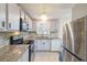 Well-lit kitchen featuring granite countertops, stainless steel appliances, and tiled backsplash at 2100 Scarbrough Rd, Stone Mountain, GA 30088