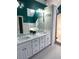 Bright bathroom featuring double sinks, granite countertop, and plenty of storage at 3120 Saint Andrews Cir, Duluth, GA 30096