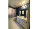 Well-lit bathroom featuring tiled floors, vanity with plenty of storage, and shower with curtain at 3120 Saint Andrews Cir, Duluth, GA 30096