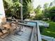 Outdoor deck showcasing dining set with a view of a fenced in pool and tree lined backyard at 3120 Saint Andrews Cir, Duluth, GA 30096