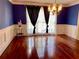 Elegant dining room with hardwood floors and wainscoting detail at 3120 Saint Andrews Cir, Duluth, GA 30096