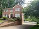 Charming two-story home with a brick facade, well-manicured lawn, and driveway at 3120 Saint Andrews Cir, Duluth, GA 30096