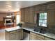 Spacious kitchen with granite countertops and stainless steel appliances at 3120 Saint Andrews Cir, Duluth, GA 30096