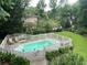 Backyard pool area with a white picket fence and well-manicured landscaping at 3120 Saint Andrews Cir, Duluth, GA 30096