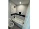 Stylish bathroom featuring a tiled bathtub, modern fixtures, and a minimalist design at 3189 Jackson, Hapeville, GA 30354