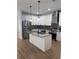 Modern kitchen with stainless steel appliances, granite countertops, and a large island at 3189 Jackson, Hapeville, GA 30354