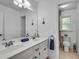 Bright bathroom featuring double sinks, modern fixtures, and separate toilet room at 3250 Cobbs Farm Nw Trl, Marietta, GA 30064