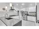 Sleek, all-white kitchen featuring stainless steel appliances and modern countertops at 3250 Cobbs Farm Nw Trl, Marietta, GA 30064