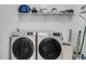 Clean laundry area with side-by-side washer and dryer, wire shelving, and ample storage space at 3250 Cobbs Farm Nw Trl, Marietta, GA 30064