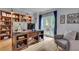 Cozy home office with hardwood floors, built-in bookshelf, large window, and desk at 3250 Cobbs Farm Nw Trl, Marietta, GA 30064
