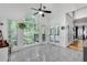 Sunroom area featuring large windows, tile flooring, and a tranquil view of the surrounding trees at 3250 Cobbs Farm Nw Trl, Marietta, GA 30064