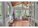 Light-filled sunroom with wood floors, large windows with curtains, and a view of the outdoors at 3250 Cobbs Farm Nw Trl, Marietta, GA 30064