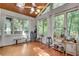 Cozy sunroom featuring wood floors, large windows with curtains, and a peaceful outdoor view at 3250 Cobbs Farm Nw Trl, Marietta, GA 30064