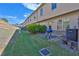 The backyard features a patio, a grill, an AC unit, greenery, a wooden fence, and the home's rear at 328 Oaktown Ct, Lawrenceville, GA 30044