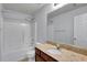 This bathroom includes a shower-tub, toilet, vanity, and a large mirror at 328 Oaktown Ct, Lawrenceville, GA 30044