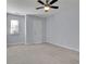 This bedroom features neutral walls, carpet, a ceiling fan, and a single window with blinds at 328 Oaktown Ct, Lawrenceville, GA 30044