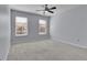 Neutral bedroom with ceiling fan and windows for natural light at 328 Oaktown Ct, Lawrenceville, GA 30044