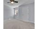 This bedroom features neutral walls, carpet, a door, and a single window with blinds at 328 Oaktown Ct, Lawrenceville, GA 30044