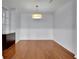 Bright dining room featuring hardwood floors, modern lighting and elegant trim for a welcoming space at 328 Oaktown Ct, Lawrenceville, GA 30044