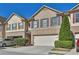 Charming brick townhome featuring a two-car garage and manicured landscaping in a well-maintained community at 328 Oaktown Ct, Lawrenceville, GA 30044