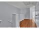 Upstairs hallway featuring hardwood floors and neutral paint at 328 Oaktown Ct, Lawrenceville, GA 30044