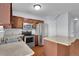 Modern kitchen with wooden cabinets, stainless steel appliances, and sink with faucet at 328 Oaktown Ct, Lawrenceville, GA 30044