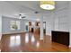 Open concept living room with hardwood floors, ceiling fan and views of the kitchen with stainless steel appliances at 328 Oaktown Ct, Lawrenceville, GA 30044