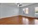 Bright living room featuring hardwood floors, a ceiling fan, and a window for natural light at 328 Oaktown Ct, Lawrenceville, GA 30044