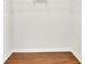 Walk-in closet includes laminate flooring and storage shelves at 328 Oaktown Ct, Lawrenceville, GA 30044