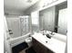 Bathroom with shower-tub combination, single sink, and window for natural light at 532 Oakside Pl, Acworth, GA 30102