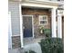 Inviting entrance with stone accents, dark door and a welcoming 'WELCOME' sign at 532 Oakside Pl, Acworth, GA 30102