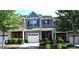 Charming townhome with gray siding, white garage door and driveway with manicured landscaping at 532 Oakside Pl, Acworth, GA 30102