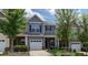 Charming townhome featuring stone accents, a one car garage, and well maintained landscaping at 532 Oakside Pl, Acworth, GA 30102