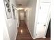 Hallway with hardwood floors, decorative wall art, and white paneled doors at 532 Oakside Pl, Acworth, GA 30102