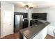 Modern kitchen featuring stainless steel appliances, dark cabinets, and hardwood floors at 532 Oakside Pl, Acworth, GA 30102