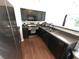 Contemporary kitchen with stainless steel appliances, dark cabinets, and spacious countertops at 532 Oakside Pl, Acworth, GA 30102