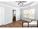 Light-filled main bedroom with tray ceiling and an adjacent bathroom, featuring a comfortable aesthetic at 532 Oakside Pl, Acworth, GA 30102